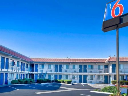 The image shows a two-story motel building with a 