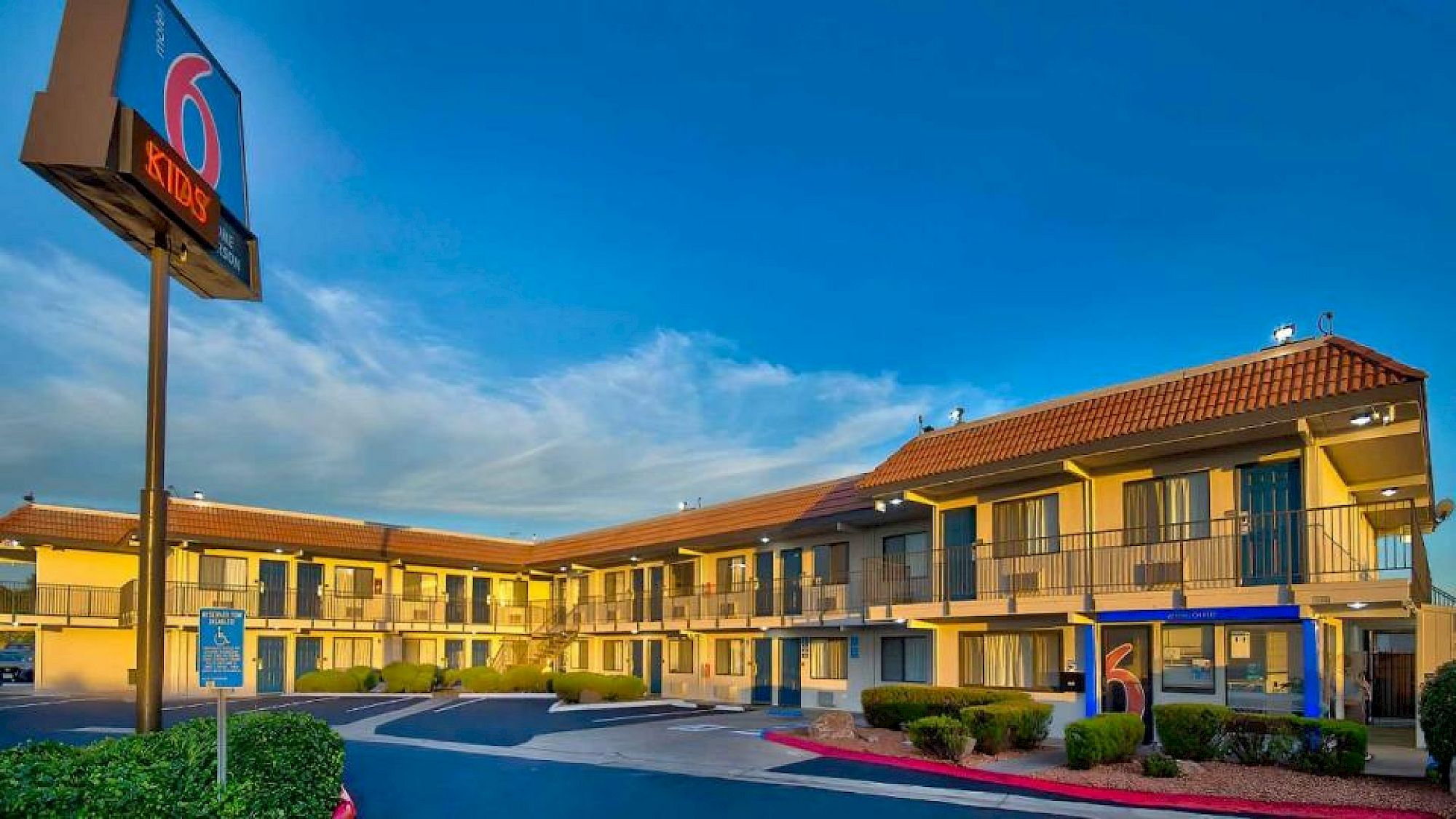 A two-story motel with a sign displaying the number 