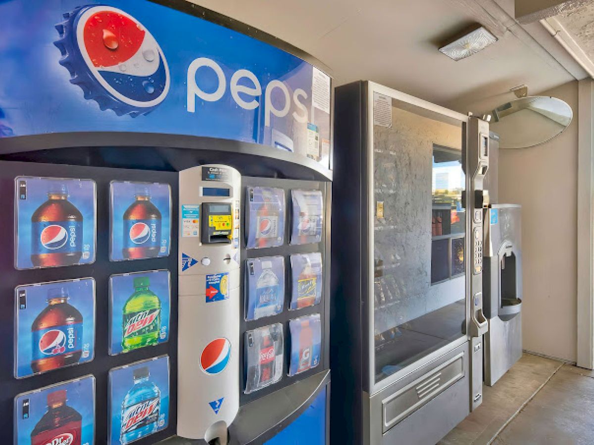 The image shows a vending machine area with Pepsi branding, displaying various beverage options like sodas.