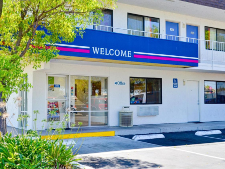 The image shows the entrance of a motel with a 